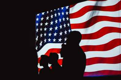 silhouette of four person with flag of united states background
